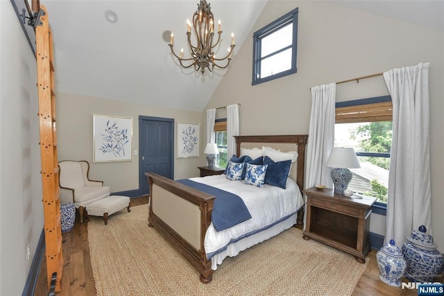  - bedroom featuring a chandelier, light wood-style flooring, high vaulted ceiling, multiple windows, and a closet