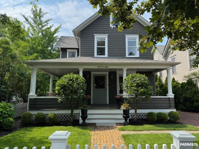  - view of front of property featuring a porch and a front yard