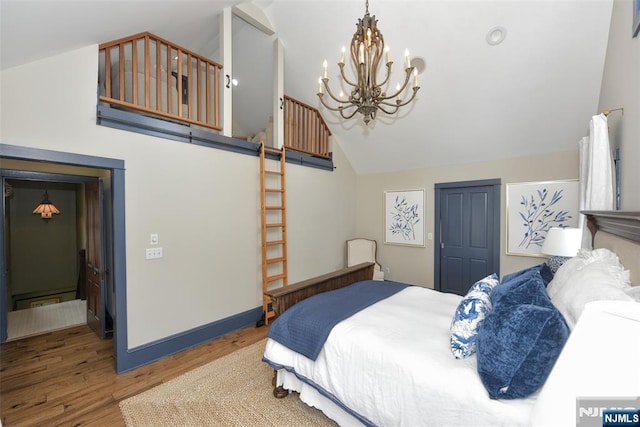  - bedroom with a chandelier, wood finished floors, and high vaulted ceiling