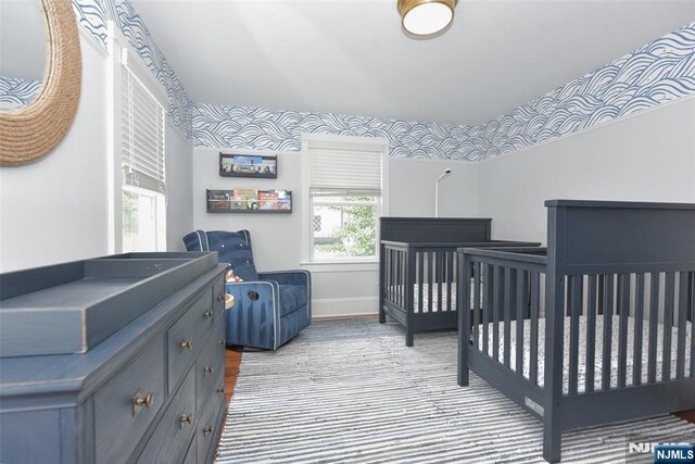  - bedroom with baseboards and a crib
