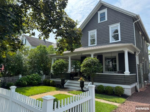  - american foursquare style home featuring a porch