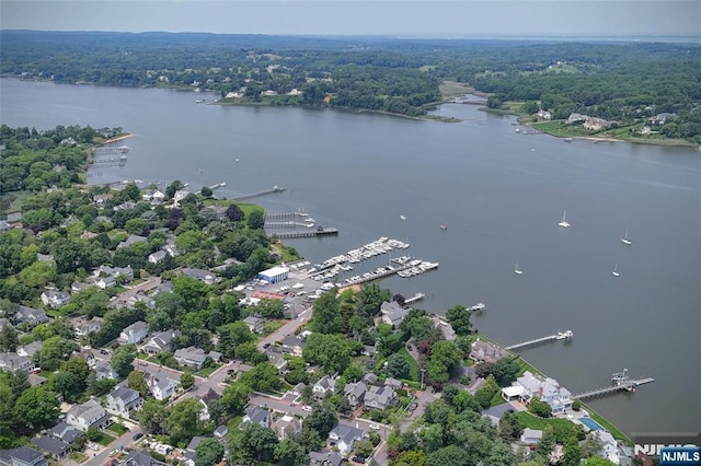  - aerial view of property's location with a nearby body of water and a forest