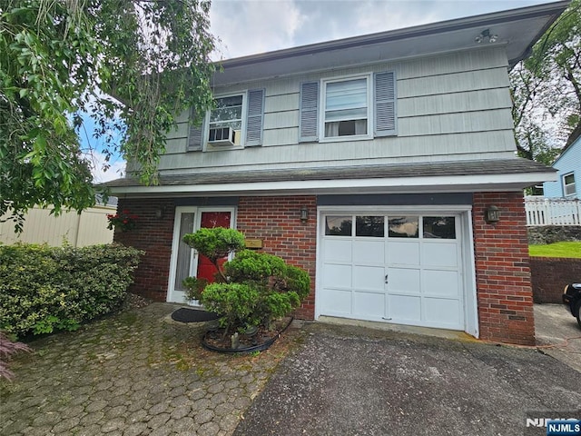 37 Pocohontas Path, Lincoln Park Borough, NJ 07035 - view of front of property featuring an attached garage, brick siding, asphalt driveway, and cooling unit