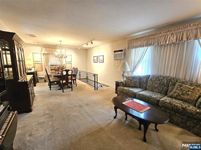 37 Pocohontas Path, Lincoln Park Borough, NJ 07035 - living room with a chandelier, light colored carpet, a wall mounted air conditioner, and track lighting