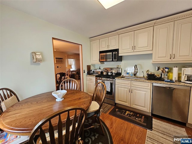 37 Pocohontas Path, Lincoln Park Borough, NJ 07035 - kitchen featuring stainless steel appliances, a sink, light wood-style flooring, a wall mounted air conditioner, and cream cabinets