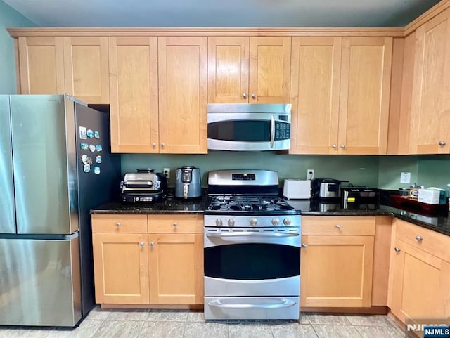 200 Dey St Unit 283, Harrison, NJ 07029 - kitchen with stainless steel appliances, light brown cabinets, and dark stone countertops