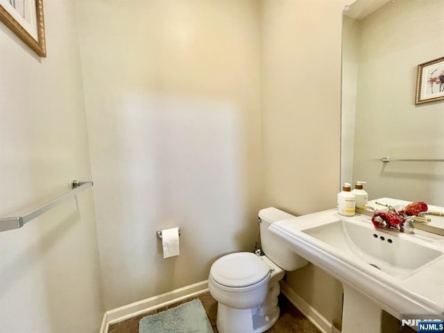 200 Dey St Unit 283, Harrison, NJ 07029 - half bathroom featuring toilet and baseboards