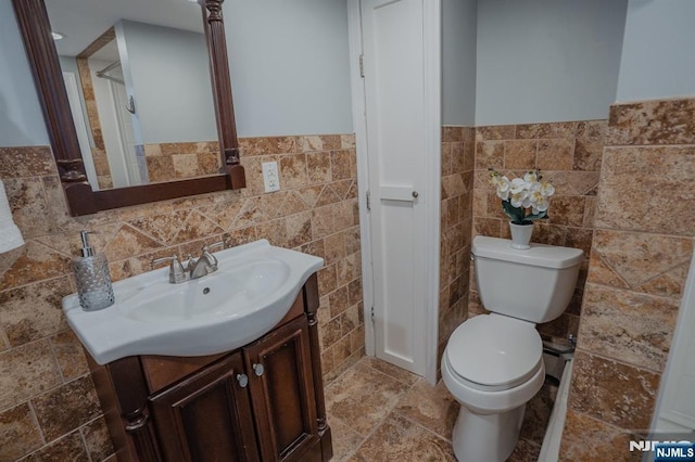 42 Berton Pl, Nutley, NJ 07110 - bathroom featuring tile walls, vanity, toilet, and wainscoting