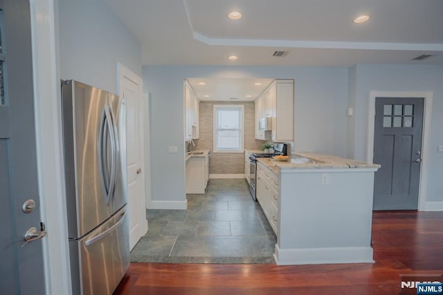 42 Berton Pl, Nutley, NJ 07110 - kitchen featuring stainless steel appliances, baseboards, white cabinetry, light stone counters, and recessed lighting