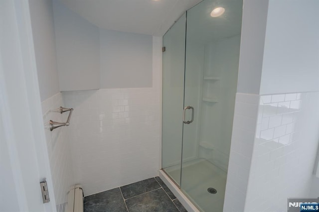 42 Berton Pl, Nutley, NJ 07110 - full bath featuring a baseboard heating unit, tile walls, a stall shower, tile patterned flooring, and a wainscoted wall