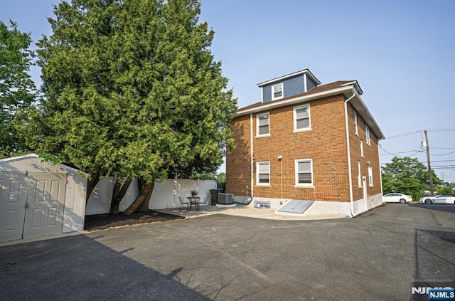 42 Berton Pl, Nutley, NJ 07110 - back of property with brick siding and central air condition unit