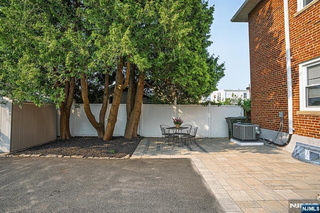 42 Berton Pl, Nutley, NJ 07110 - fenced backyard with central air condition unit and a patio area