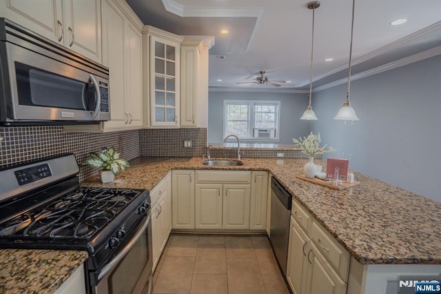 42 Berton Pl, Nutley, NJ 07110 - kitchen with appliances with stainless steel finishes, a sink, crown molding, a peninsula, and decorative backsplash