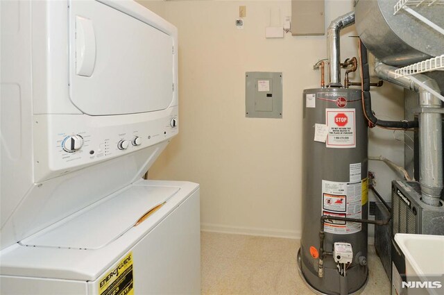 103 Four Seasons Unit 103, Wayne, NJ 07470 - laundry area with gas water heater, stacked washer / dryer, electric panel, and baseboards