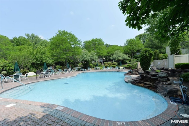 103 Four Seasons Unit 103, Wayne, NJ 07470 - community pool featuring a patio and view of scattered trees