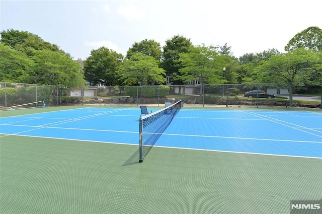 103 Four Seasons Unit 103, Wayne, NJ 07470 - view of tennis court featuring community basketball court and view of wooded area