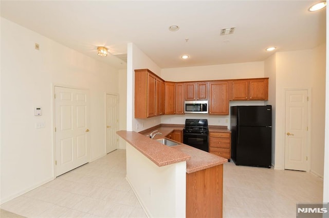 103 Four Seasons Unit 103, Wayne, NJ 07470 - kitchen featuring freestanding refrigerator, stove, stainless steel microwave, brown cabinets, and a sink