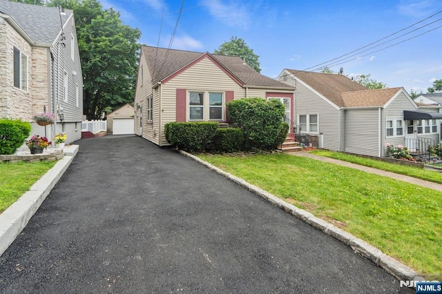 82 Elston St, Bloomfield, NJ 07003 - bungalow with an outdoor structure, a front lawn, and a detached garage