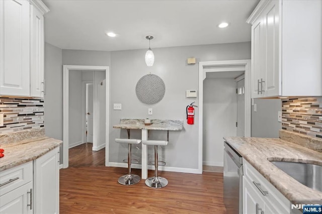 82 Elston St, Bloomfield, NJ 07003 - kitchen with stainless steel dishwasher, tasteful backsplash, white cabinetry, baseboards, and recessed lighting