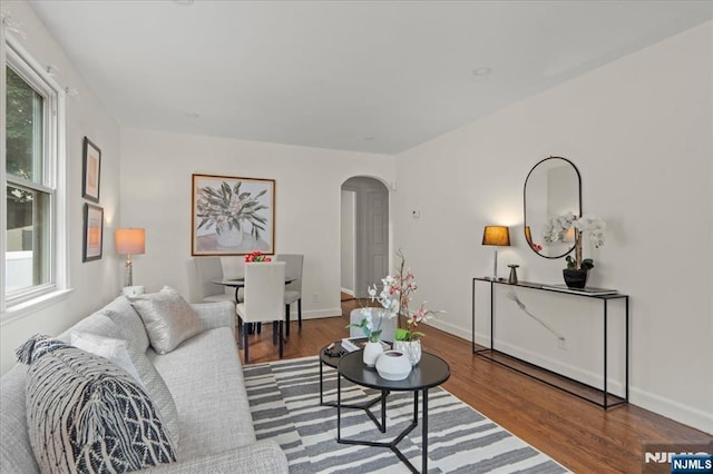 82 Elston St, Bloomfield, NJ 07003 - living room featuring arched walkways, plenty of natural light, wood finished floors, and baseboards