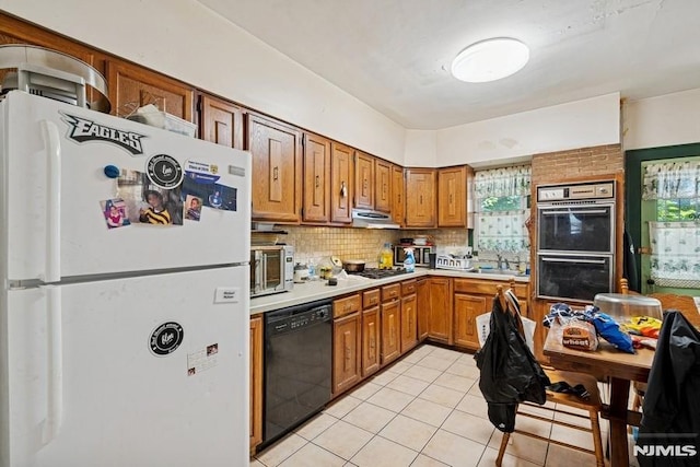 361/2 Hecker St, Newark, NJ 07103 - kitchen featuring freestanding refrigerator, dishwasher, double wall oven, under cabinet range hood, and decorative backsplash