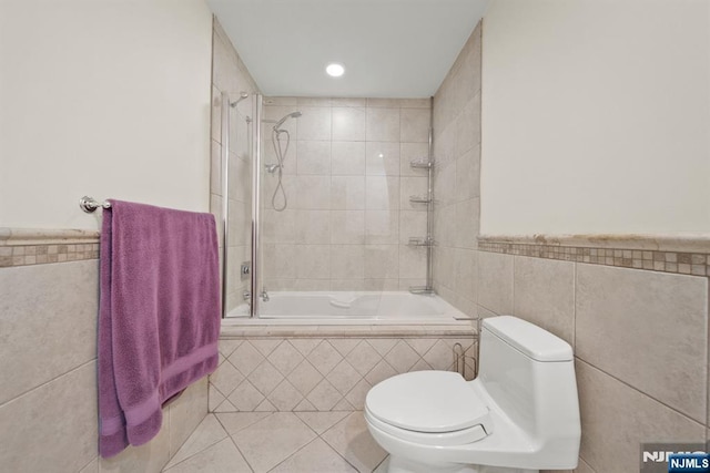 36-15 Garden View Ter, Fair Lawn, NJ 07410 - bathroom featuring tile walls, tiled shower / bath combo, tile patterned floors, and wainscoting