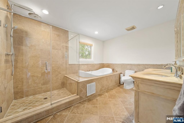 36-15 Garden View Ter, Fair Lawn, NJ 07410 - bathroom with a stall shower, a garden tub, vanity, recessed lighting, and a wainscoted wall