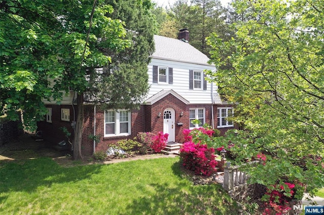 85 Paulin Blvd, Leonia, NJ 07605 - colonial inspired home with brick siding, a chimney, and a front lawn