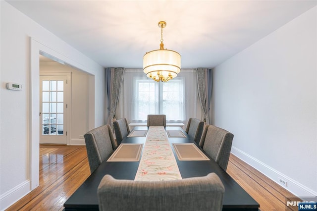85 Paulin Blvd, Leonia, NJ 07605 - dining area featuring a chandelier, baseboards, and wood finished floors