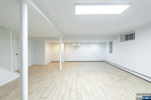 85 Paulin Blvd, Leonia, NJ 07605 - finished basement featuring light wood-style flooring, baseboards, baseboard heating, and electric panel