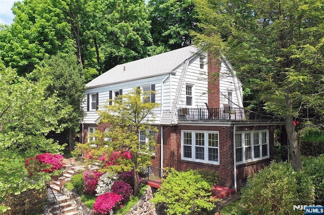 85 Paulin Blvd, Leonia, NJ 07605 - view of front of house with brick siding and a gambrel roof