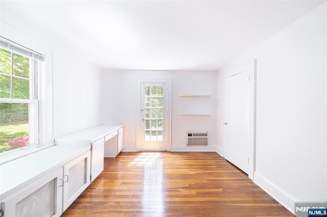 85 Paulin Blvd, Leonia, NJ 07605 - unfurnished room with plenty of natural light, light wood-type flooring, a wall mounted air conditioner, and baseboards