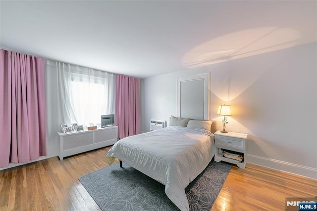 85 Paulin Blvd, Leonia, NJ 07605 - bedroom featuring wood finished floors, a wall mounted air conditioner, and baseboards