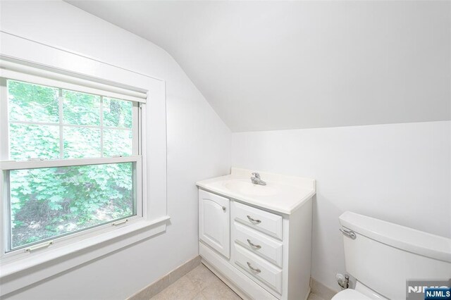 85 Paulin Blvd, Leonia, NJ 07605 - bathroom with vaulted ceiling, toilet, vanity, plenty of natural light, and tile patterned floors