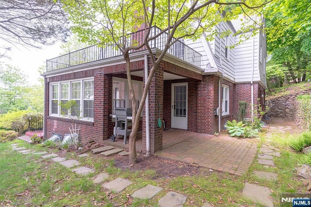 85 Paulin Blvd, Leonia, NJ 07605 - back of house featuring a balcony, brick siding, and a patio