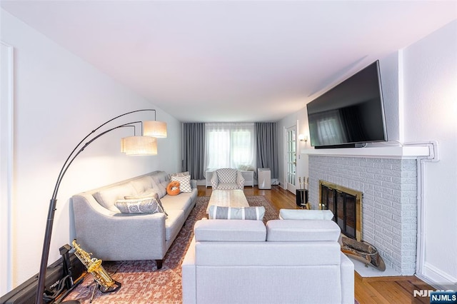 85 Paulin Blvd, Leonia, NJ 07605 - living area with a brick fireplace, wood finished floors, and baseboards