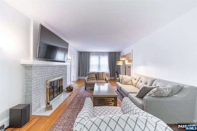 85 Paulin Blvd, Leonia, NJ 07605 - living area with wood finished floors, a brick fireplace, and baseboards