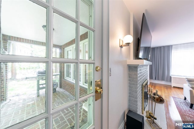 85 Paulin Blvd, Leonia, NJ 07605 - doorway featuring a brick fireplace and wood finished floors