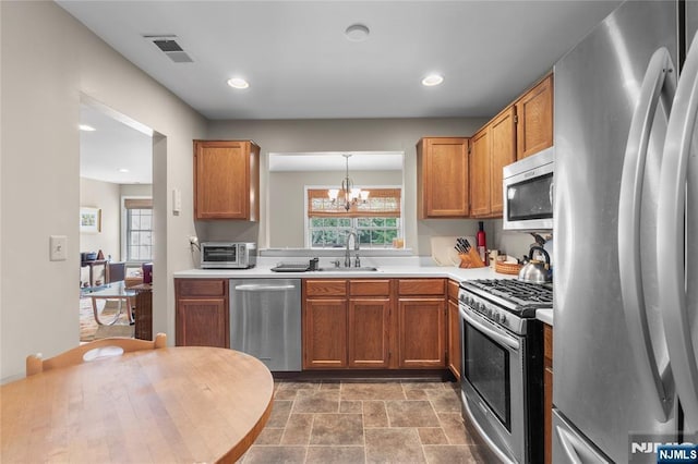35 Spruce Ct Unit 116, Clifton, NJ 07014 - kitchen featuring stainless steel appliances, a chandelier, light countertops, brown cabinets, and recessed lighting