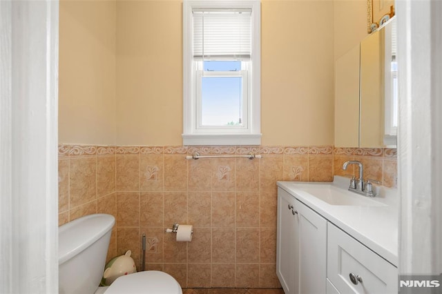 3 Drury Ln, Fort Lee, NJ 07024 - bathroom featuring tile walls, toilet, vanity, and a wainscoted wall