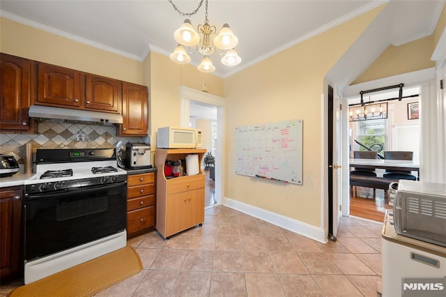 3 Drury Ln, Fort Lee, NJ 07024 - kitchen featuring gas range, under cabinet range hood, white microwave, crown molding, and backsplash