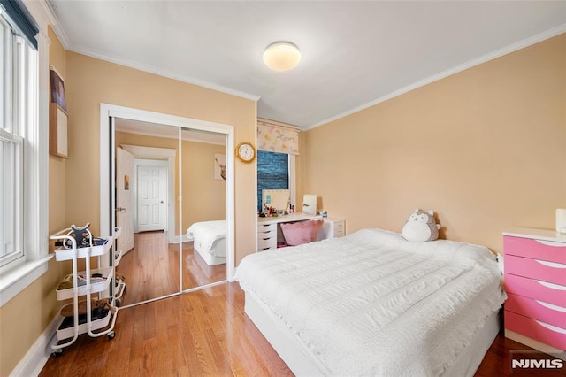 3 Drury Ln, Fort Lee, NJ 07024 - bedroom with crown molding, wood finished floors, baseboards, and a closet