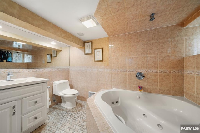 3 Drury Ln, Fort Lee, NJ 07024 - full bathroom featuring a tub with jets, vanity, toilet, tile walls, and tile patterned floors
