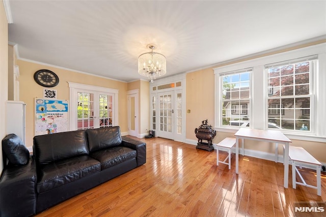 3 Drury Ln, Fort Lee, NJ 07024 - living area with french doors, a chandelier, light wood-style floors, ornamental molding, and healthy amount of natural light