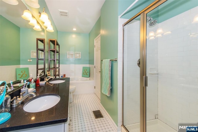 129 Eisenhower Ln Unit 2109, Wood Ridge, NJ 07075 - full bath featuring a garden tub, a shower stall, double vanity, a wainscoted wall, and toilet