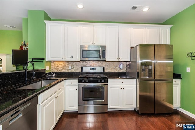 129 Eisenhower Ln Unit 2109, Wood Ridge, NJ 07075 - kitchen featuring stainless steel appliances, a sink, white cabinets, tasteful backsplash, and recessed lighting
