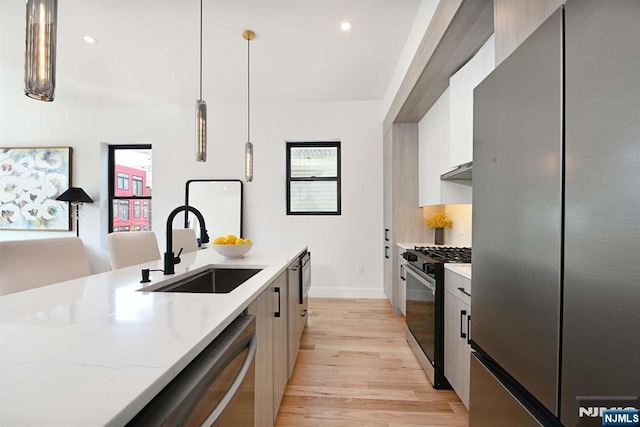 262 Webster Ave Unit 2, Jersey City, NJ 07307 - kitchen with stainless steel appliances, light wood-style floors, plenty of natural light, hanging light fixtures, and recessed lighting
