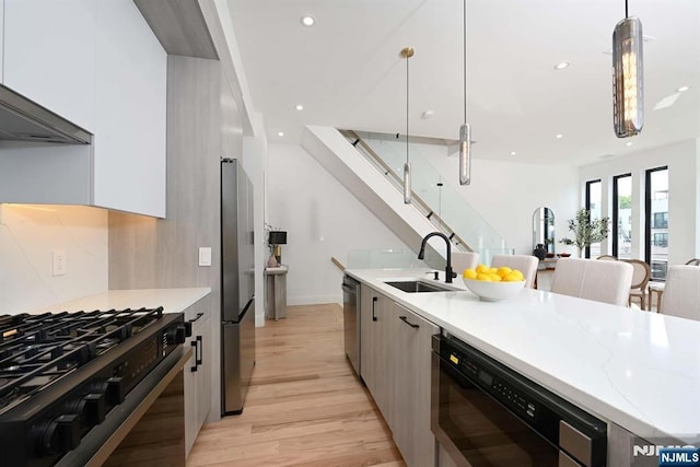262 Webster Ave Unit 2, Jersey City, NJ 07307 - kitchen featuring modern cabinets, appliances with stainless steel finishes, light wood finished floors, recessed lighting, and pendant lighting