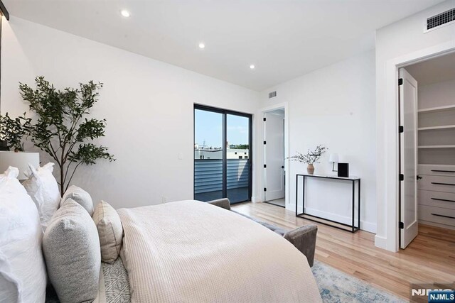 262 Webster Ave Unit 2, Jersey City, NJ 07307 - bedroom with light wood finished floors, access to exterior, recessed lighting, and a spacious closet