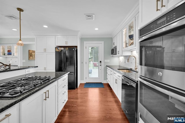 39 N 5th St, Park Ridge, NJ 07656 - kitchen with black appliances, crown molding, dark wood-type flooring, decorative light fixtures, and glass insert cabinets